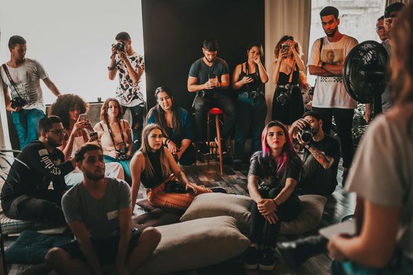 A diverse group of people starting their yoga journey in a bright studio.